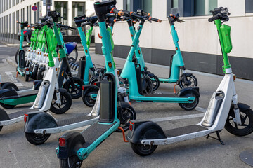 Electric scooters parked on urban sidewalk for sharing © jokuephotography