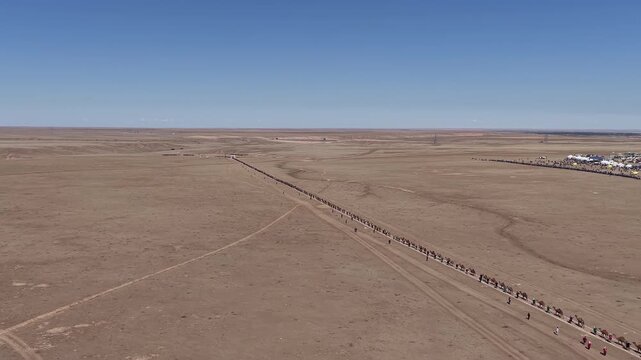 Aerial view of a long camel caravan traveling through the gobi desert