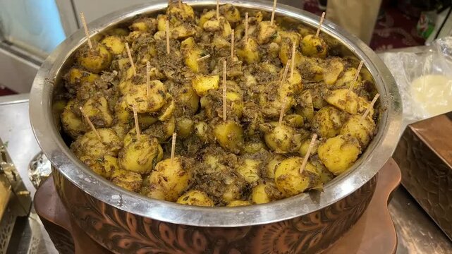 Famous Kolkata Alu Dum; traditional Bengali-style spicy potato curry served at a popular local food stall near Rabindra Sarobar, Kolkata, West Bengal, India.