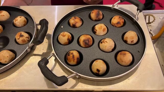 Authentic Litti Chokha being prepared on a contemporary electric stove, showcasing the urban adaptation of this classic rustic Bihari delicacy.