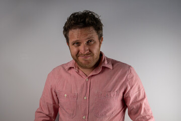 Obraz premium Man smiling with confident expression wearing casual shirt against plain background