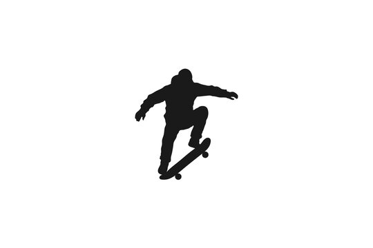 Silhouette of a skateboarder jumping performing an ollie trick
