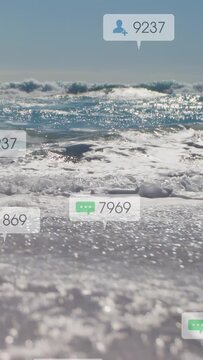 Vertical video: Shore waves rolling sparking soft icons appearing, updating counts showing interest