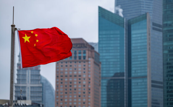 the Chinese flag with skyscrapers of Pudong in the back