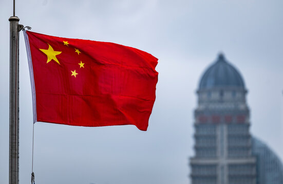 the Chinese flag with skyscrapers of Pudong in the back