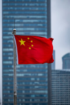 the Chinese flag with skyscrapers of Pudong in the back