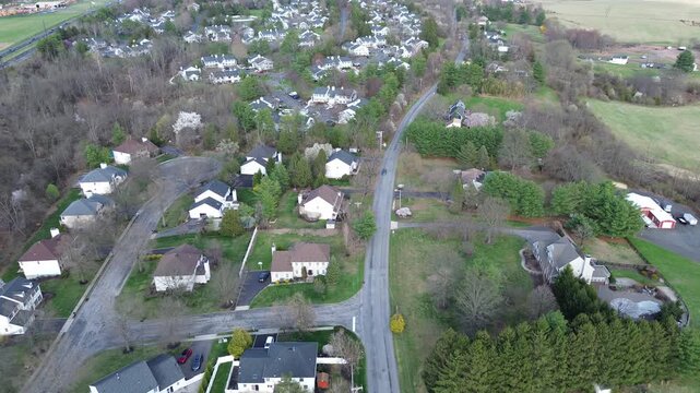 Clustered suburban blocks sit south of Old York Rd within compact Readington Township subdivision. Mixed roofing, trimmed lawns, early spring tree layered canopies, Three Bridges, New Jersey