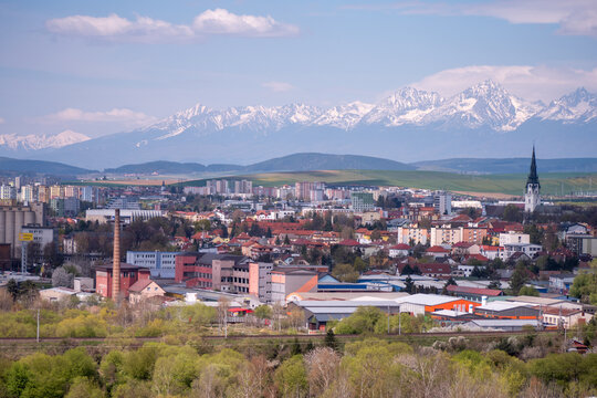Panorama of Spi&scaron;sk&aacute; Nov&aacute; Ves featuring the Roman Catholic Church of the Assumption of the Virgin Mary with the High Tatras in the background, blending history, city life, and nature.