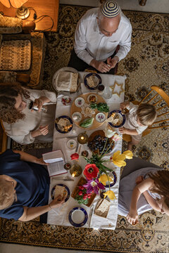 Multi generation family celebrating Passover Seder at home