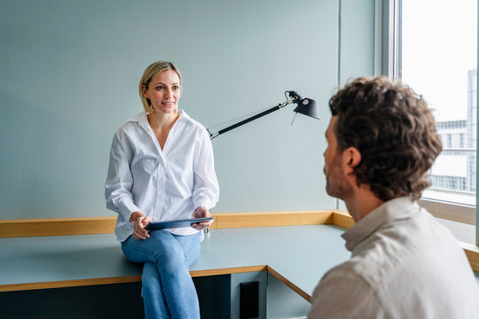 Business meeting in a modern office with two people discussing