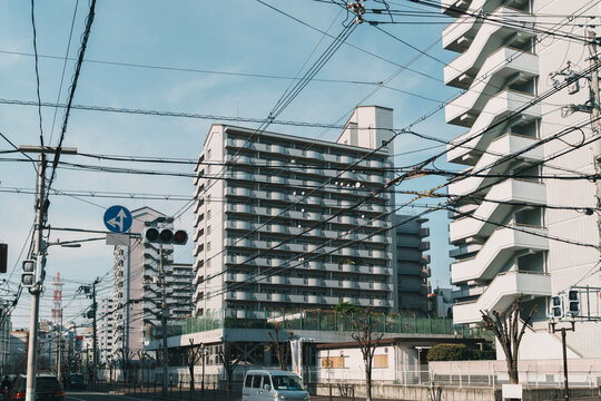Urban street view with apartment buildings and power lines in Osaka