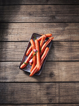 Raw organic bison sausage on wooden table with copy space
