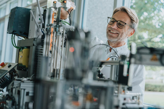 Scientist adjusting sorting machine in laboratory during research