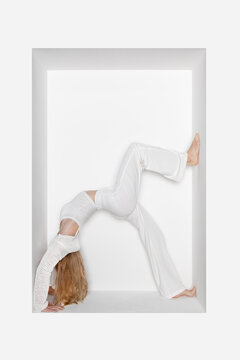 Teenager doing handstand in alcove