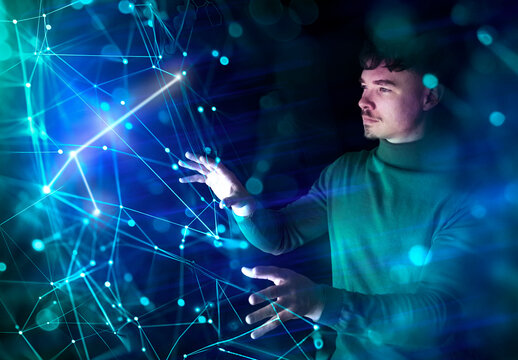 Developer interacting with a glowing digital data network indoors
