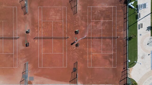 Aerial Top Down View of Clay Tennis Courts Maintenance, Camera Moving Forward