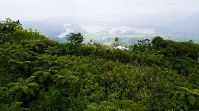 Aerial views of lush tropical hillsides, misty river deltas, and wide valleys in Lake Sebu, South Cotabato, Philippines, with distant mountains and waterfront structures.