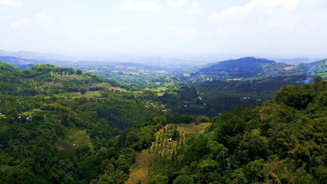 Sweeping multi-angle views of rolling green hills and valley farmlands in Lake Sebu, South Cotabato, Philippines, beneath a wide, bright open sky.