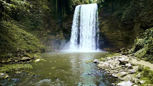 Scenic shots of powerful waterfalls plunging into natural pools and rocky streams, framed by dense tropical foliage in Lake Sebu, South Cotabato, Philippines.