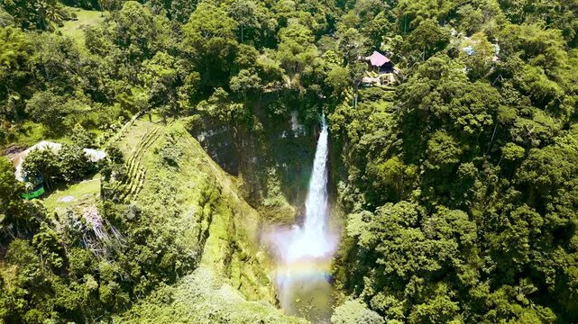 Multiple perspectives of a powerful waterfall descending through dense tropical jungle in Lake Sebu, South Cotabato, Philippines, with rich green foliage and steep forested valley slopes.