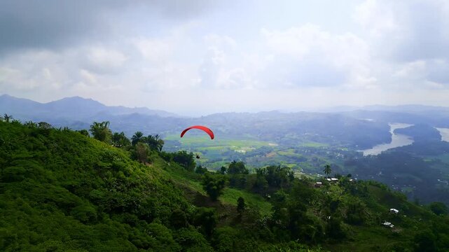 Paragliding and tandem parachute rides over the lush green hills, valleys, and rivers of Lake Sebu, South Cotabato, Philippines, under both overcast and open skies.
