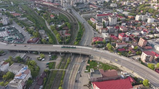 Aerial view of Alexandru cel Bun Bridge in Iasi with tram crossing above railway tracks and urban traffic in daylight