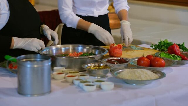 Fresh vegetables, rice, herbs, and spices are prepared and mixed in a bowl for traditional stuffed dishes. Focus on ingredients, preparation process, and authentic cuisine in a clean kitchen setting.