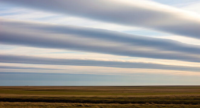 Vast landscape with rolling clouds at sunset