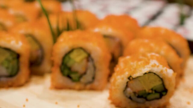 Metal Tongs Picking Up California Sushi Roll From Buffet Display