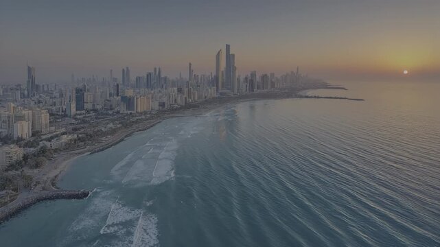 Kuwait city skyline at sunrise, aerial view with vibrant ocean waves and coastal urban landscape