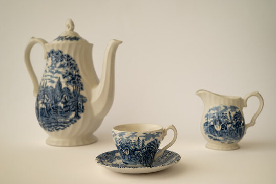 Vintage porcelain tea set with cup, teapot and creamer