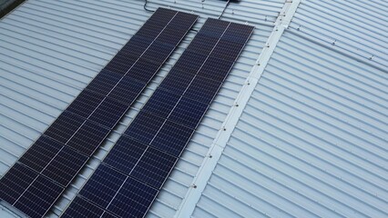 Fototapeta premium Solar panel array on large warehouse structure