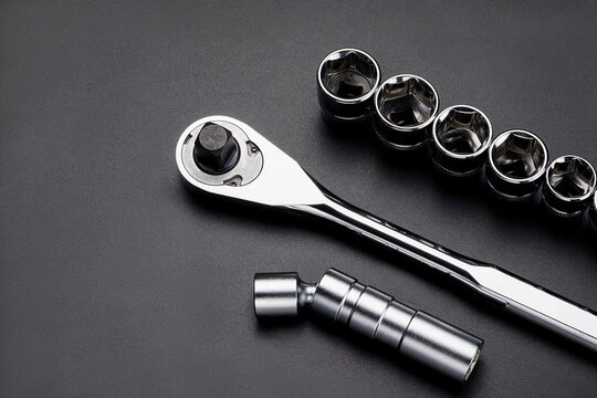 Professional chrome vanadium socket wrench set featuring a ratchet handle multiple socket heads and a universal joint extension on a dark textured background for mechanical work