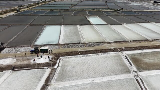 Aerial Zoom Into Workers Loading Salt From Salt Pans Coastal Production