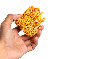 Fototapeta premium Hand holding a piece of spicy dry instant noodle block isolated on white background