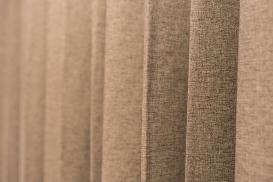 Brown curtain with flowing pleats and folds, perfect for decorating a luxurious room or setting