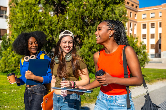 Diverse students walking and laughing on university campus