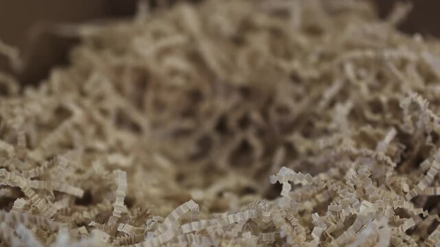 Cardboard box. White mug. Shredded paper. Slow motion video. . High quality 4k footage