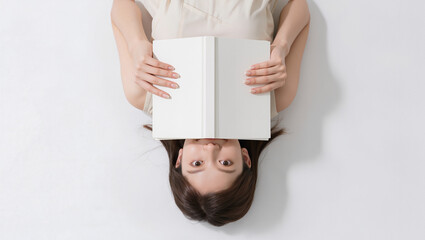 Woman Hiding Face Behind Book