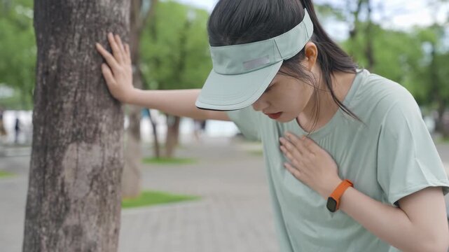 Athletic fitness sportswoman girl feels headache, dizziness, migraine or heavier breathing difficulty, suffer from heat stroke outdoors when jogging or exercise with strong sunlight in summer season