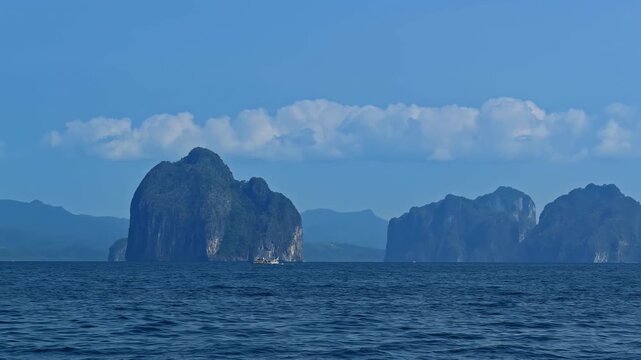 Limestone karst cliffs jut out of the water near Palawan Island in the Philippines.