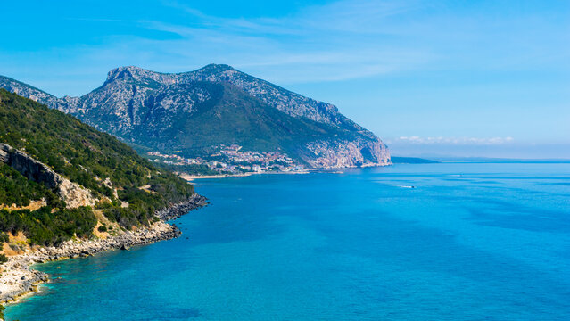 Panoramic view of Cala Gonone bay with sea and mountains on Sardinia island, Italy