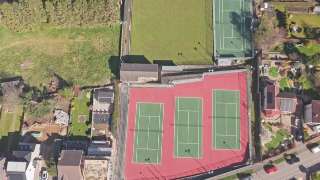 Stocksbridge Tennis Club Linden Crescent Stocksbridge Sheffield South Yorkshire England S36 1DF with three acrylic hard courts, ITF layout, fenced perimeter and adjacent grass pitch, top down ascent s