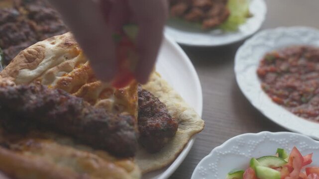 Close-up of Adana kebab menu on the Turkish flag