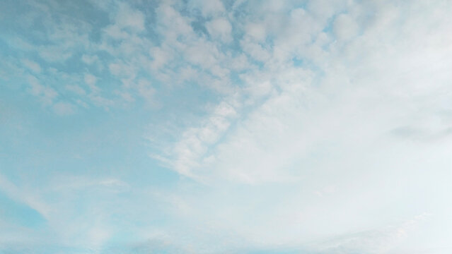 Minimalist Bright Blue Sky with Soft White Clouds Background