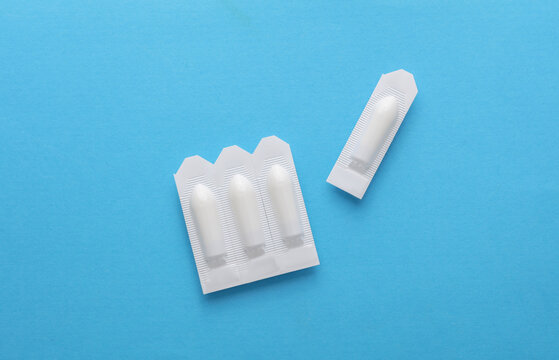 Rectal suppositories on a blue background