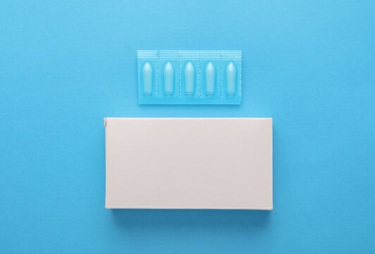 Rectal suppositories with box on a blue background