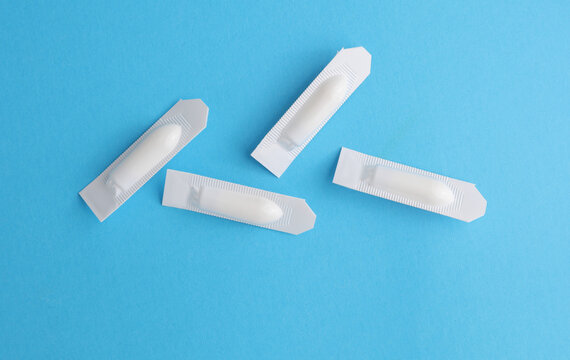 Rectal suppositories on a blue background