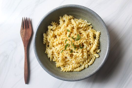 a bowl of fusilli pasta with fork