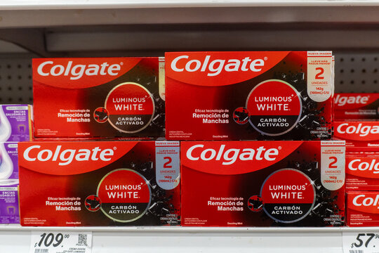 Villa de Alvarez, Colima. April 14, 2026: Red Boxes of Colgate Luminous White Charcoal Activated Toothpaste Displayed in a Retail Shelf